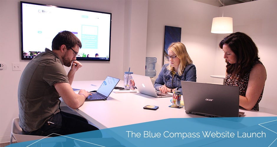 Blue Compass employees sitting at a table and working.